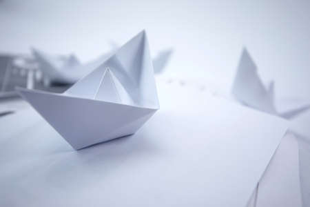 business concept - paper boats on the paperの写真素材