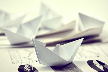 business concept - paper boats on the paperの写真素材