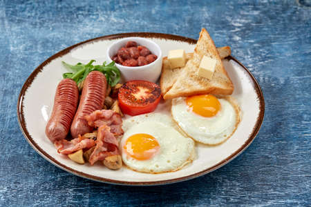 traditional breakfast with eggs and sausagesの写真素材
