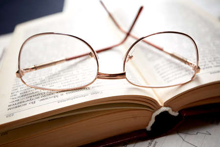 glasses on the book pagesの写真素材