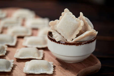 raw dumplings on teh wooden boardの写真素材