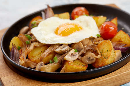 baked potatoes with mushrooms and eggsの写真素材