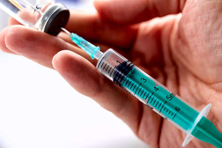 Vaccine in vial with syringeの写真素材