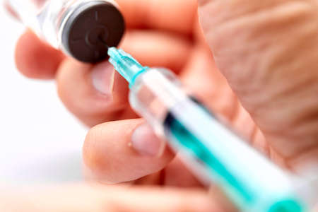 Vaccine in vial with syringeの写真素材