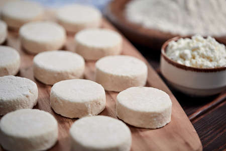 raw cottage cheese pancakes on the wooden boardの写真素材