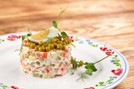 Olivier salad on the wooden tableの写真素材