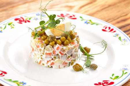 Olivier salad on the wooden tableの写真素材
