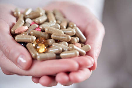pills on the woman's handsの写真素材