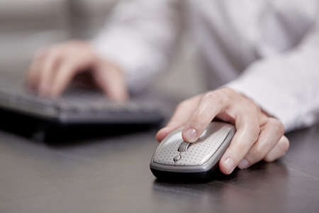 close up of businesswoman using computer mouseの写真素材