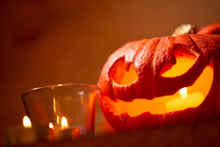 Halloween pumpkin and small candlesの写真素材