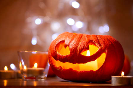 Halloween pumpkin and small candlesの写真素材
