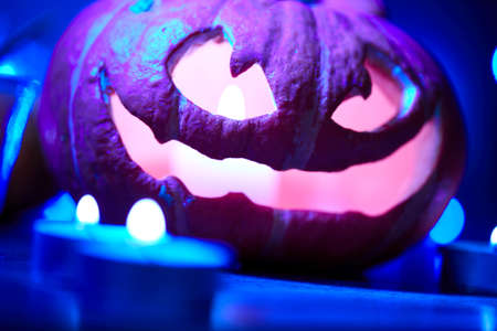 Halloween pumpkin and small candlesの写真素材