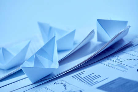 business concept, paper boats on the documentsの写真素材