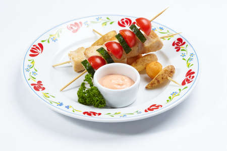 chicken kebab with sauce and herbsの写真素材