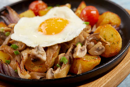 baked potatoes with mushrooms and eggsの写真素材