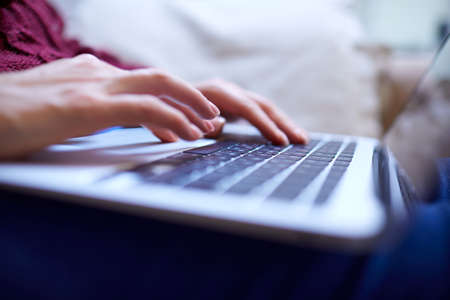 Beautiful woman relaxing at home with notebookの写真素材