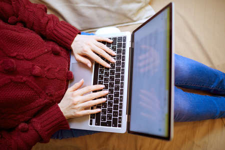 Beautiful woman relaxing at home with notebookの写真素材
