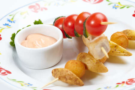 chicken kebab with sauce and herbsの写真素材