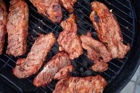 Pork neck getting grilled outdoorsの写真素材