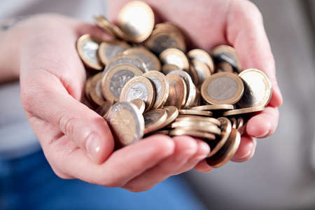 woman hands with euro coinsの写真素材