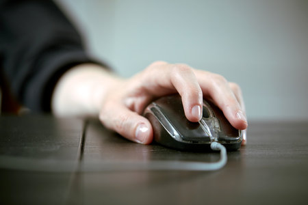 close up of businesswoman using computer mouseの写真素材