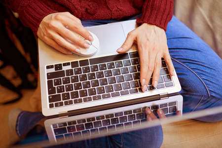 Beautiful woman relaxing at home with notebookの写真素材