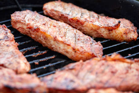 Pork neck getting grilled outdoorsの写真素材