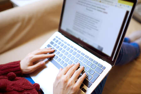 Beautiful woman relaxing at home with notebookの写真素材
