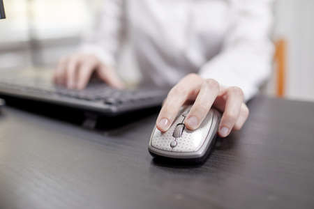 close up of businesswoman using computer mouseの写真素材