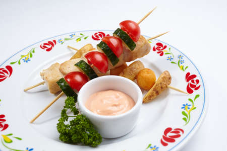 chicken kebab with sauce on white backgroundの写真素材