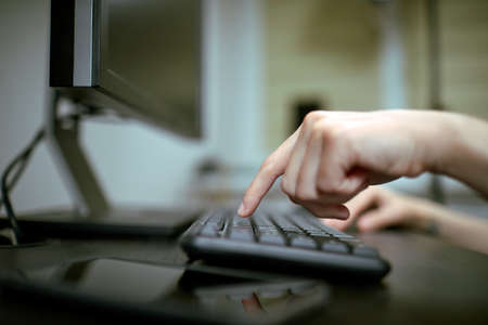 Female hands or woman office worker typing on the keyboardの写真素材