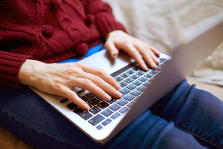 Beautiful woman relaxing at home with notebookの写真素材