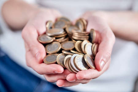 woman hands with euro coinsの写真素材