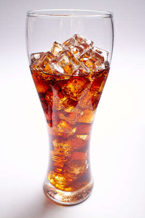 cola with ice cubes on whiteの写真素材