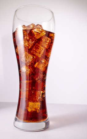 cola with ice cubes on whiteの写真素材