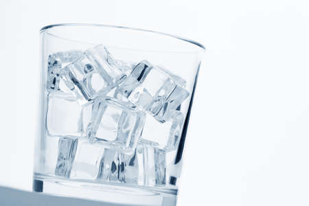 glass with ice cubes on whiteの写真素材