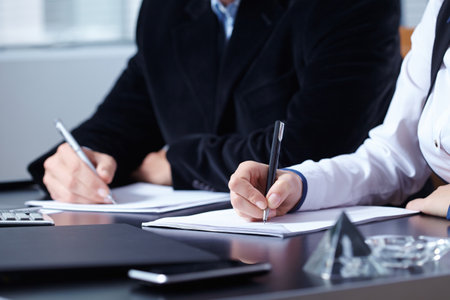 man and woman hands signing contract paper in officeの写真素材