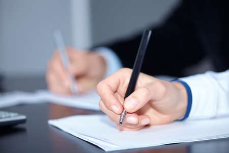 man and woman hands signing contract paper in officeの写真素材