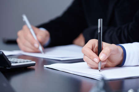 man and woman hands signing contract paper in office