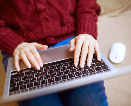 Beautiful woman relaxing at home with notebookの写真素材