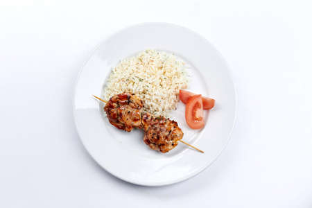 pork kebab with rice on the white plateの写真素材