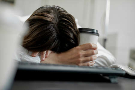 Businesswoman she was lying on the table, she was tired of working in the office.の写真素材