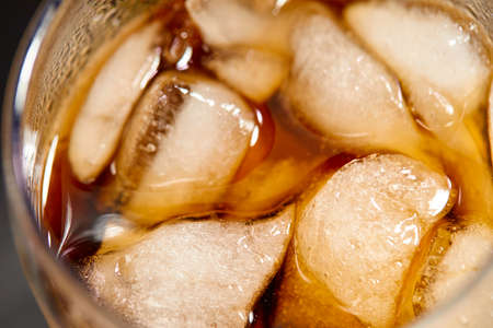Ice cubes in cola beverageの写真素材