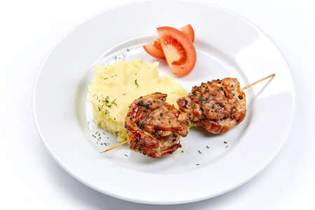 pork kebab with mashed potatoes and vegetablesの写真素材