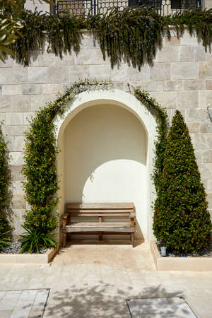 Vintage wooden bench with decorative plantsの写真素材