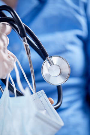 Male Doctor with stethoscope and maskの写真素材