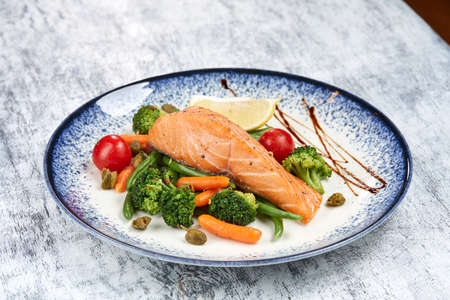 salmon steak with roasted vegetablesの写真素材