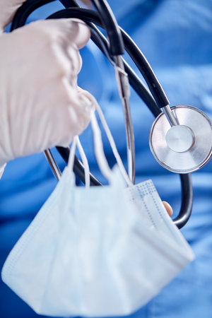 Male Doctor with stethoscope and maskの写真素材