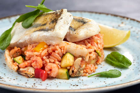white fish with rice and vegetablesの写真素材