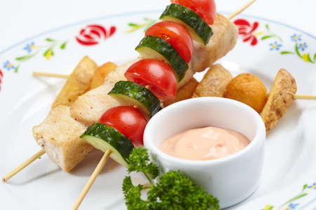 chicken kebab with sauce and vegetablesの写真素材